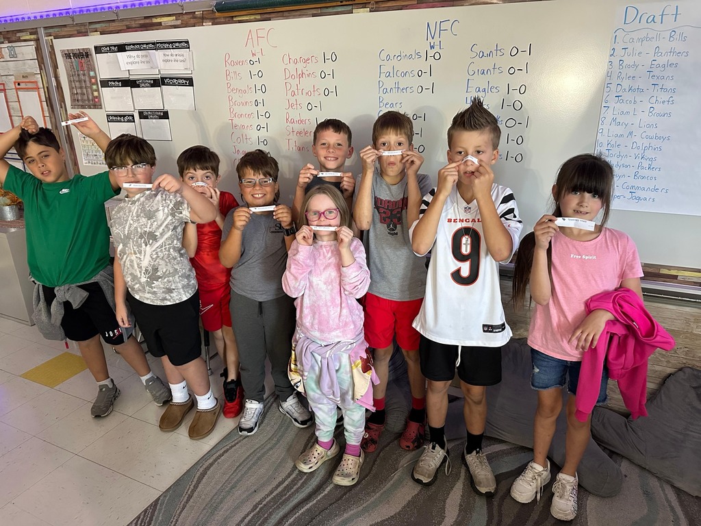 Students holding up their draft picks