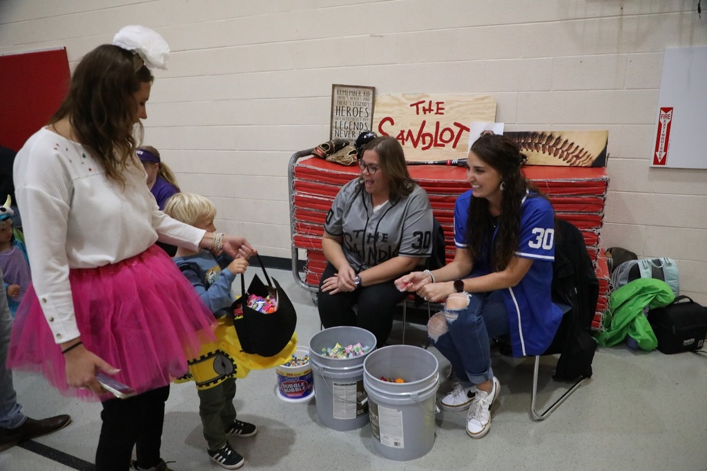 Students dressed up in costume getting candy for trunk or treat