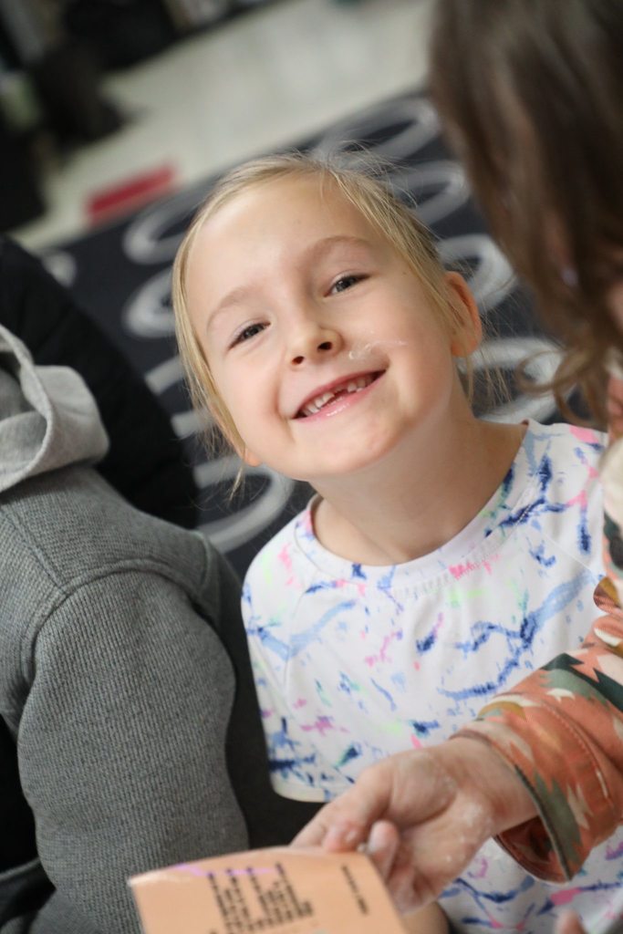 Student with flour on her cheek