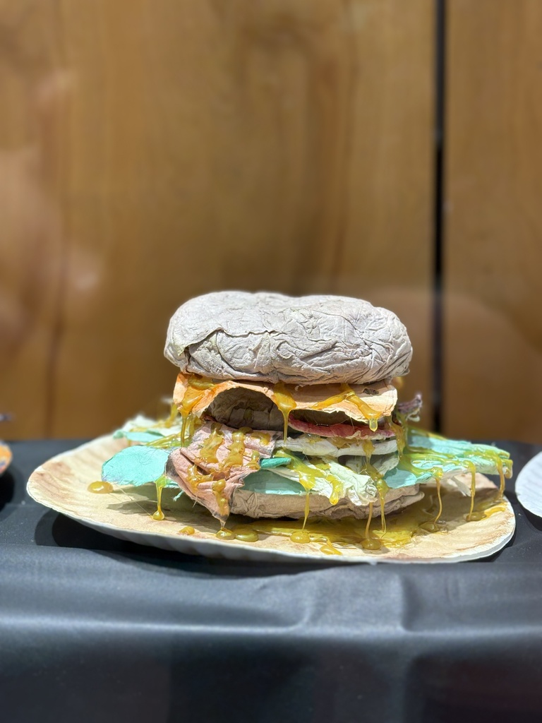 Cheeseburger art sculpture created out of toilet paper