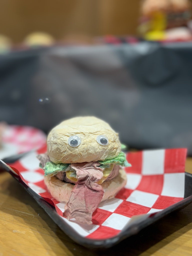 Cheeseburger art sculpture created out of toilet paper