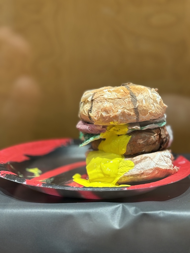 Cheeseburger art sculpture created out of toilet paper