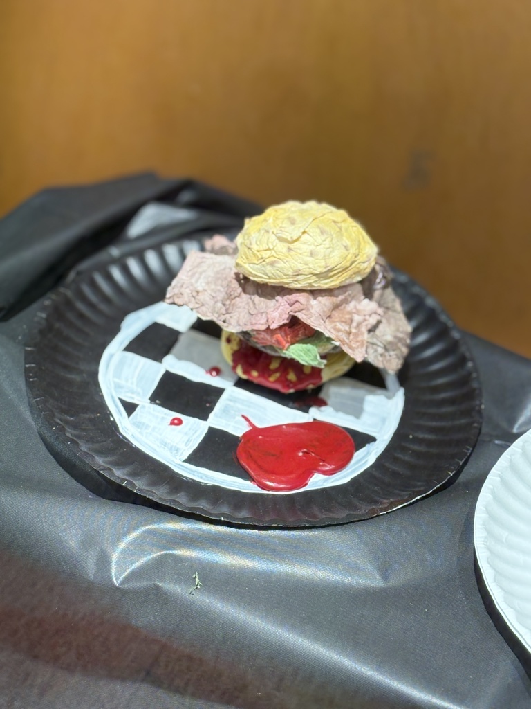 Cheeseburger art sculpture created out of toilet paper