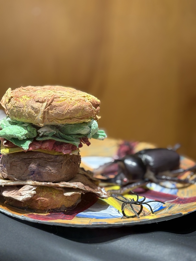 Cheeseburger art sculpture created out of toilet paper