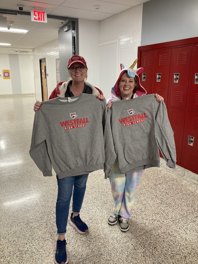 Decorated door winning staff members holding westfall sweatshirts