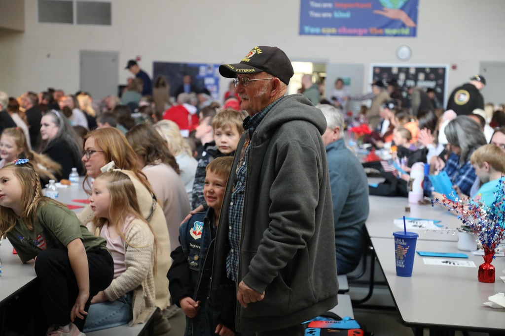 Veterans standing at Veterans Day Assembly