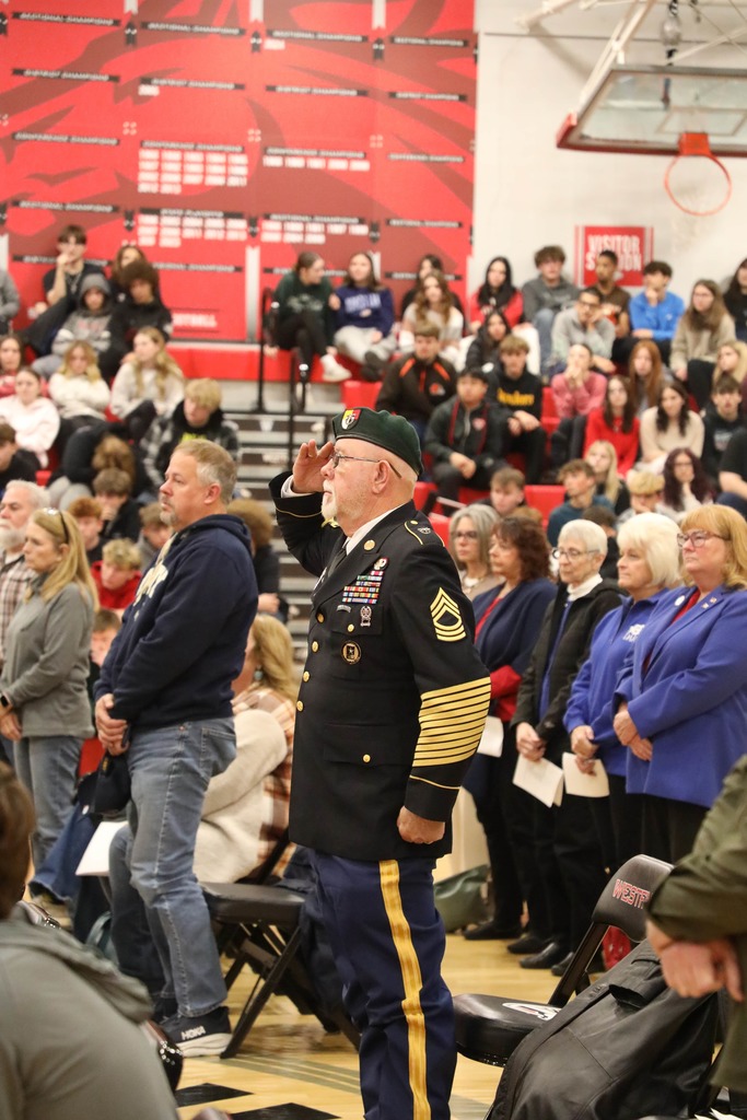 Veteran standing at Veterans Day Assembly