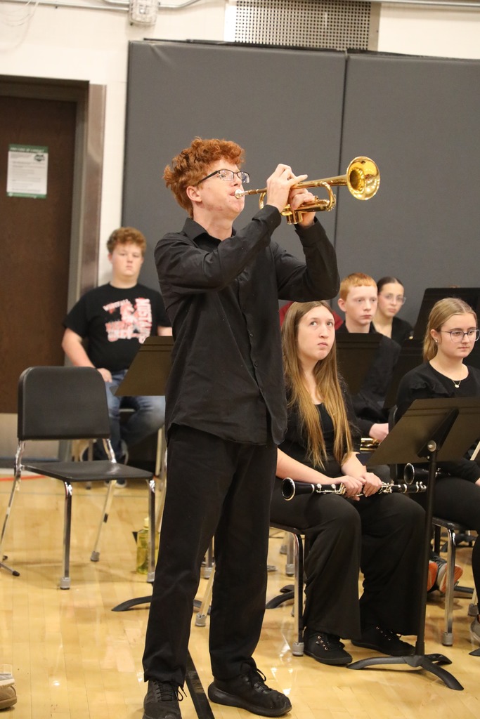 Student playing Taps on trumpet at Veterans Day Assembly