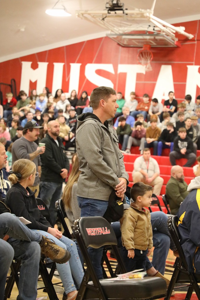 Veteran standing at Veterans Day Assembly