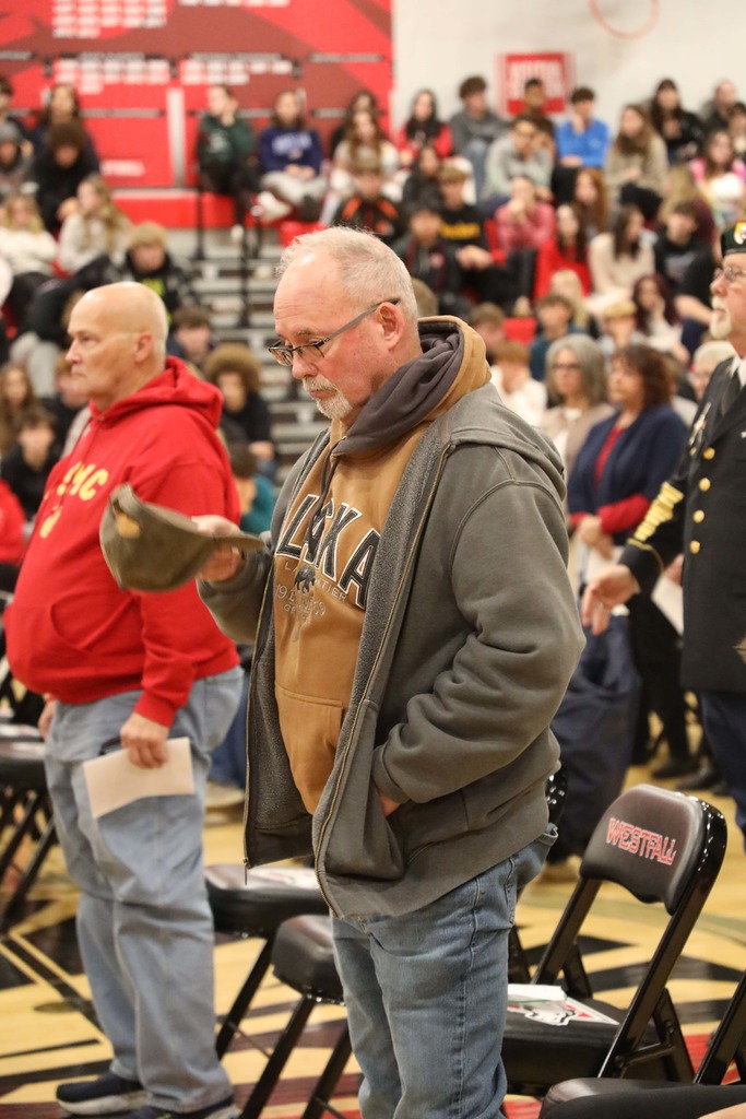 Veteran standing at Veterans Day Assembly