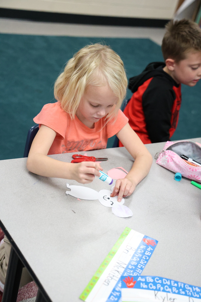 Student holding glue stick