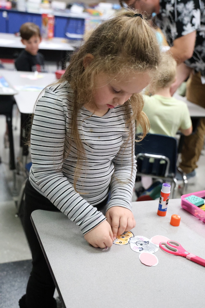 Student gluing a piece of paper down