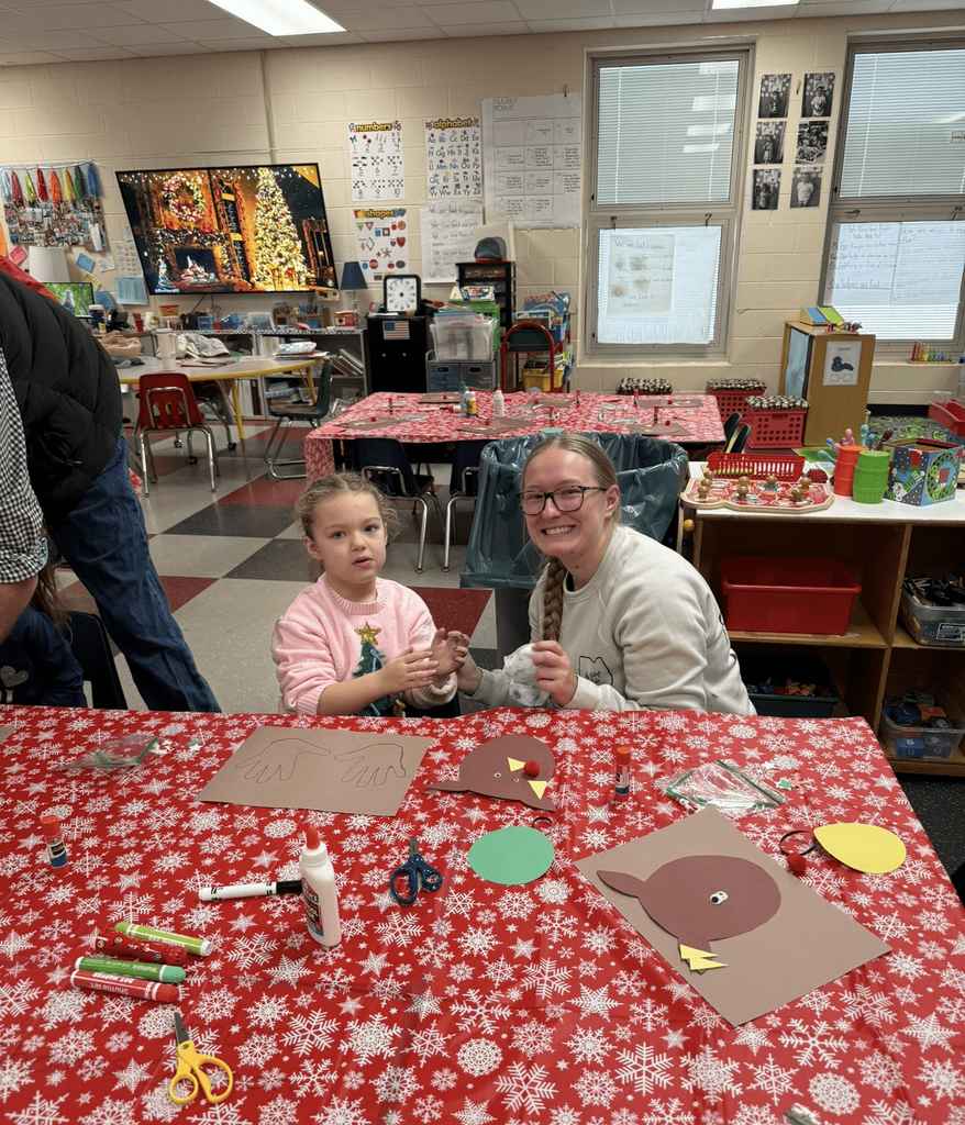 Preschooler working on a craft with adult