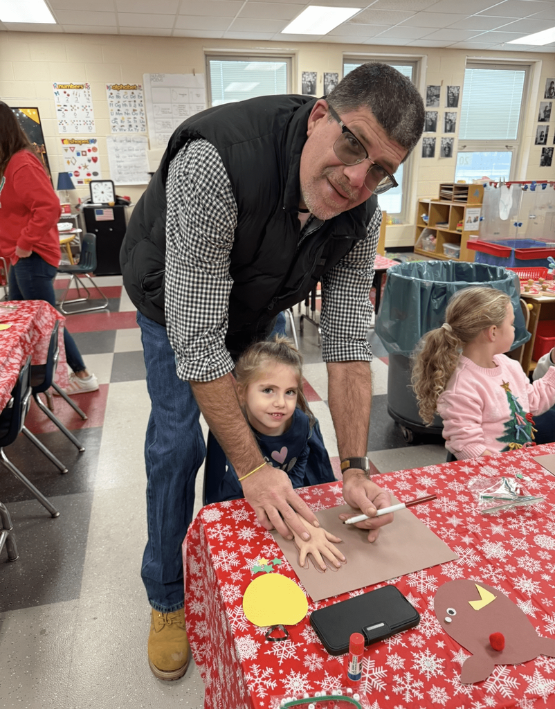 Preschooler working on a craft with adult