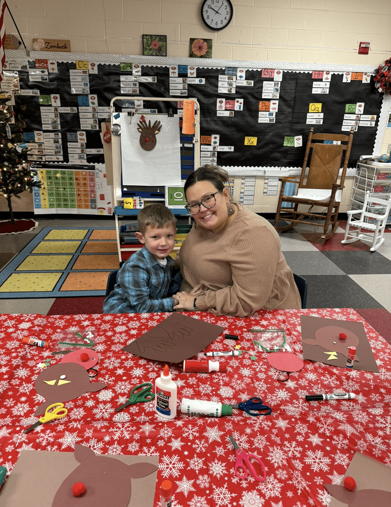 Preschooler working on a craft with adult