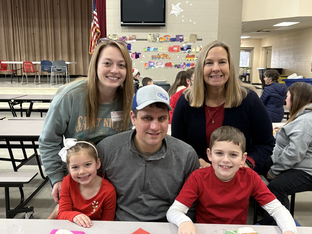 Students and parent posing with teachers