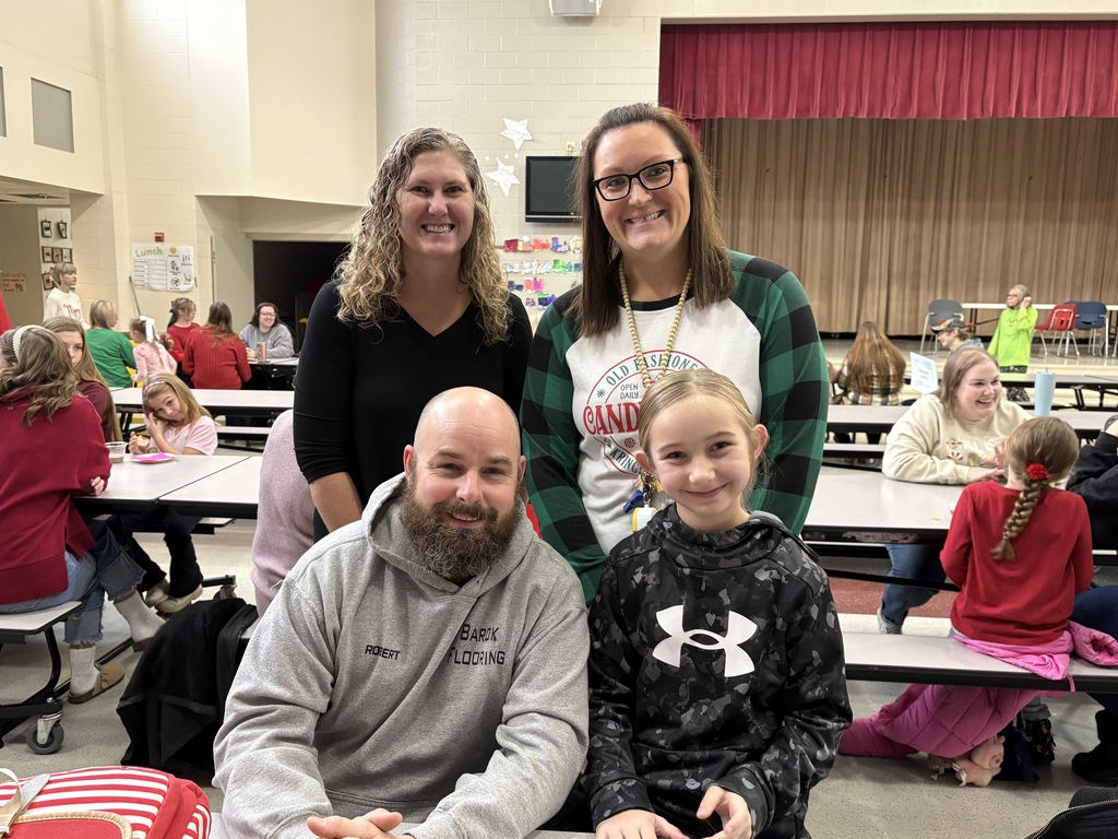 Students and parent posing with teachers