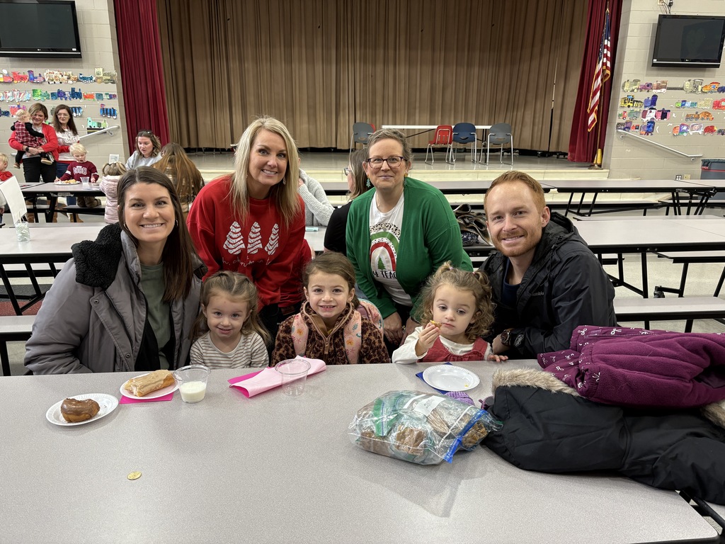 Students and parent posing with teachers