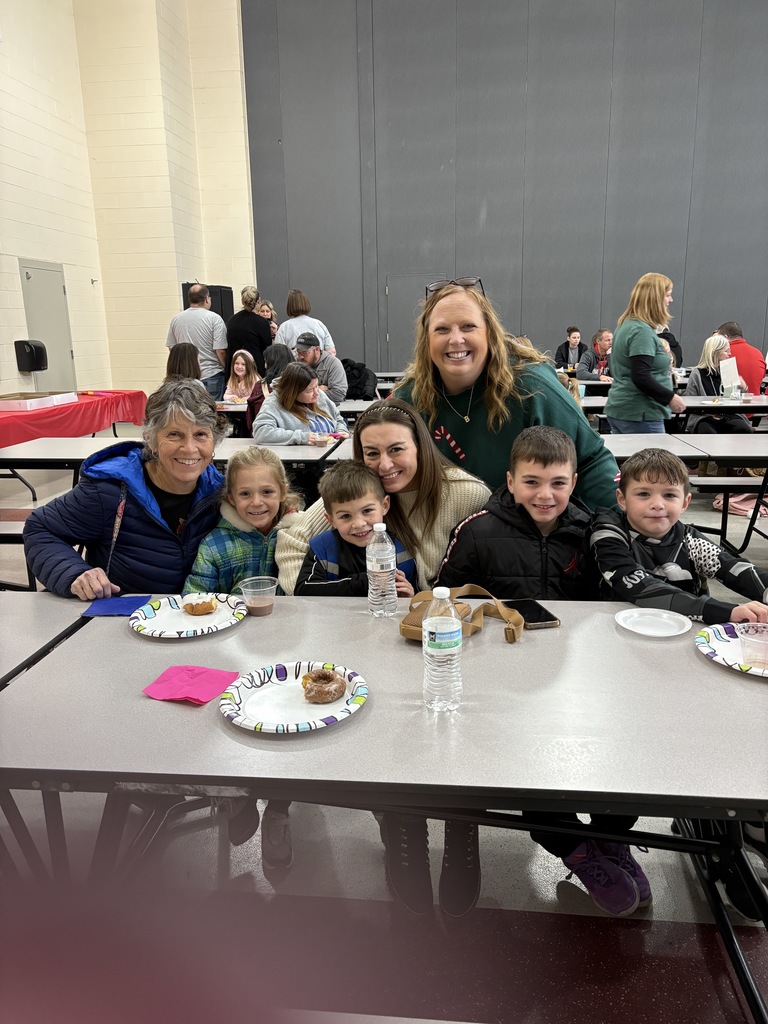Students and parent posing with teachers