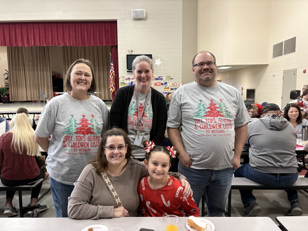 Students and parent posing with teachers