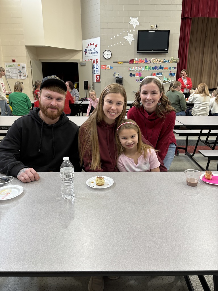 Students and parent posing with teachers