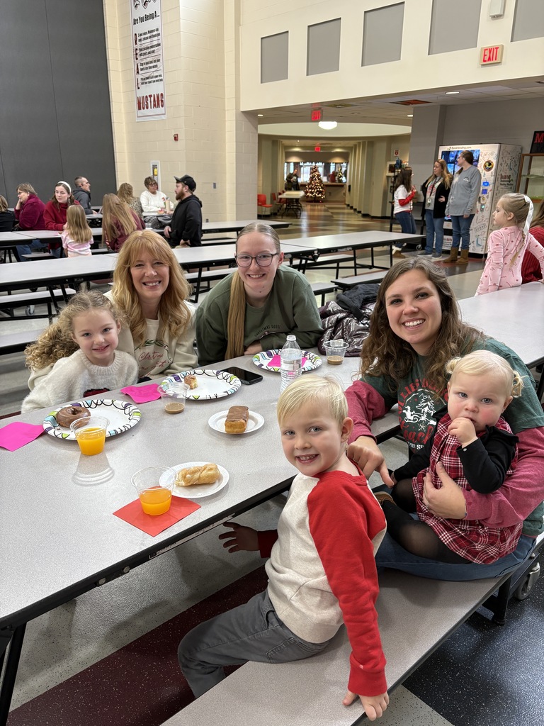 Students and parent posing with teachers