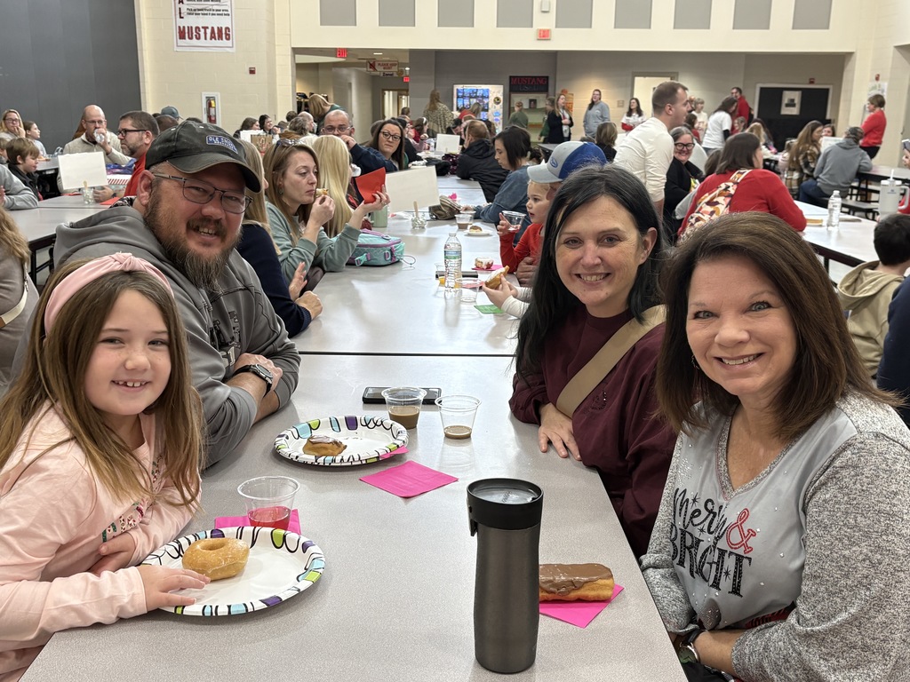 Students and parent posing with teachers