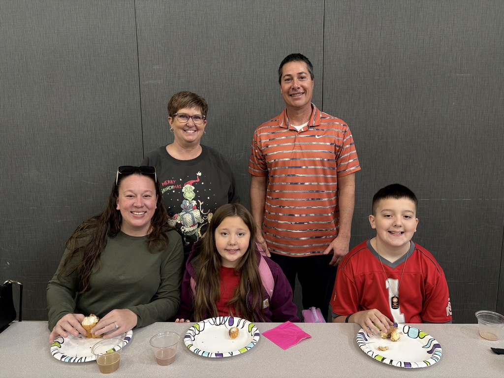Students and parent posing with teachers