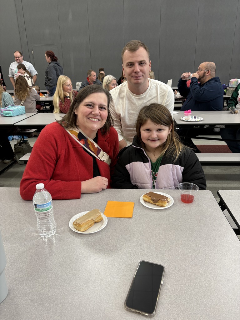 Students and parent posing with teachers