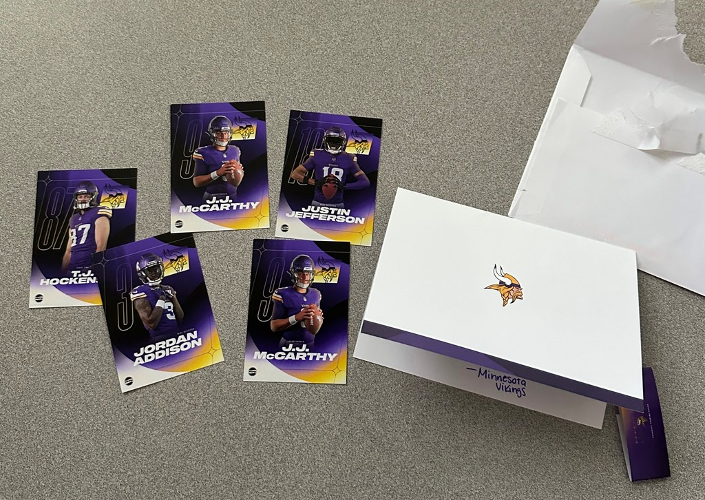 Letter from Minnesota Vikings sitting next to trading cards