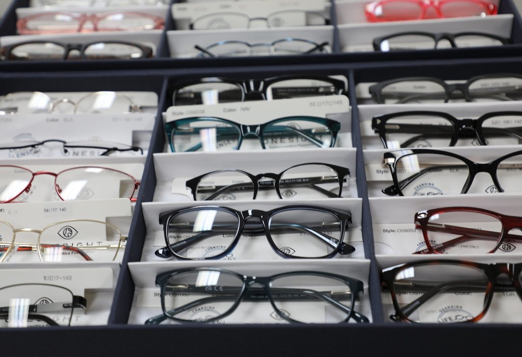 Rows of eyeglasses in a display case