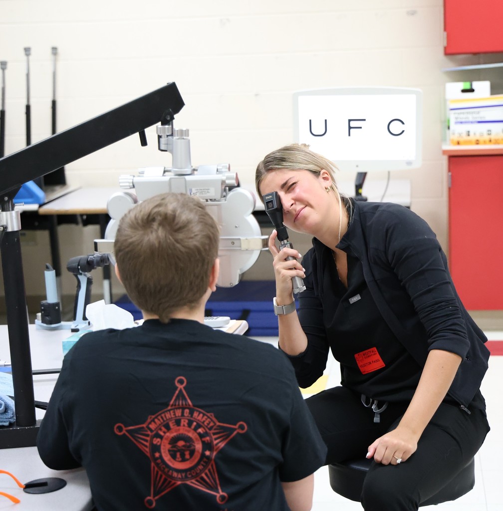 Eye doctor examining student