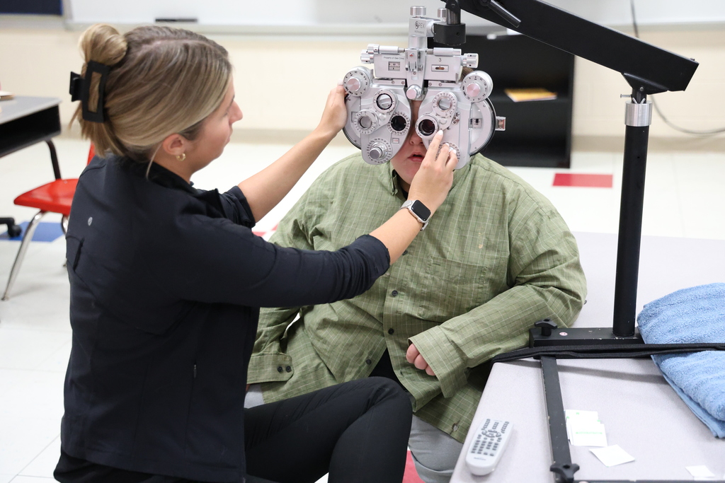 Eye doctor examining student