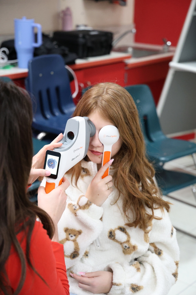 Eye doctor examining student