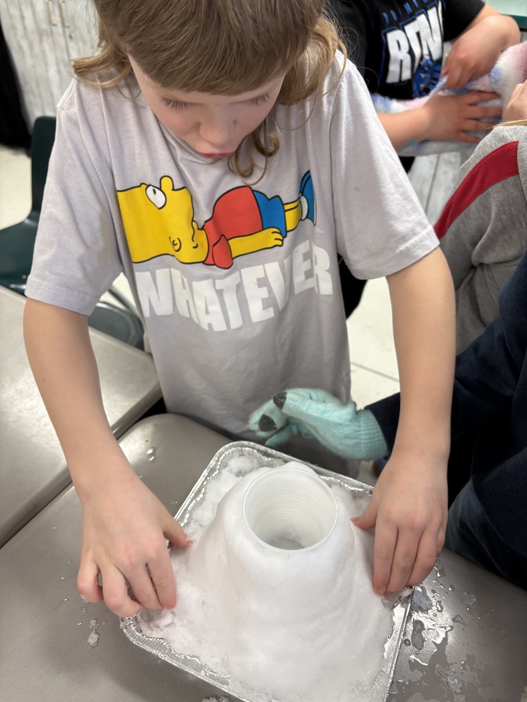 Students creating a snow volcano in the classroom