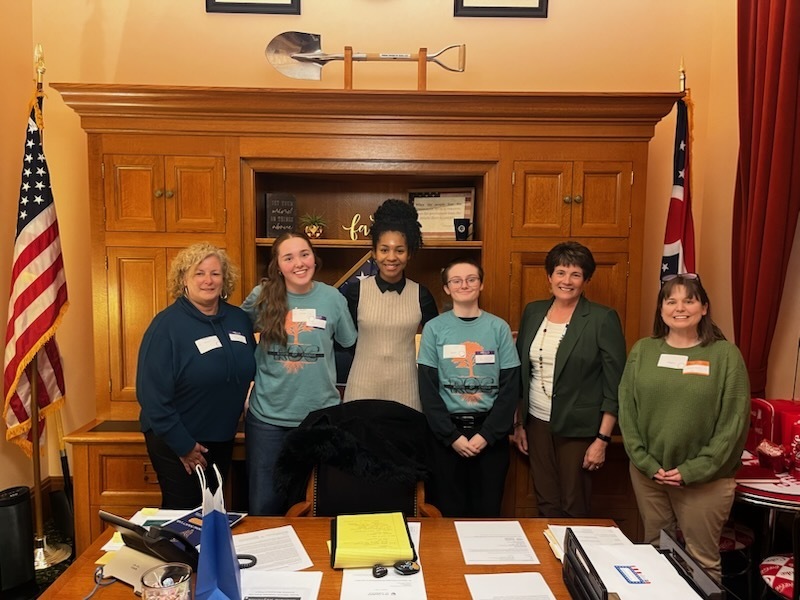 WHS Student standing with members of ROC, PAAC and government representatives