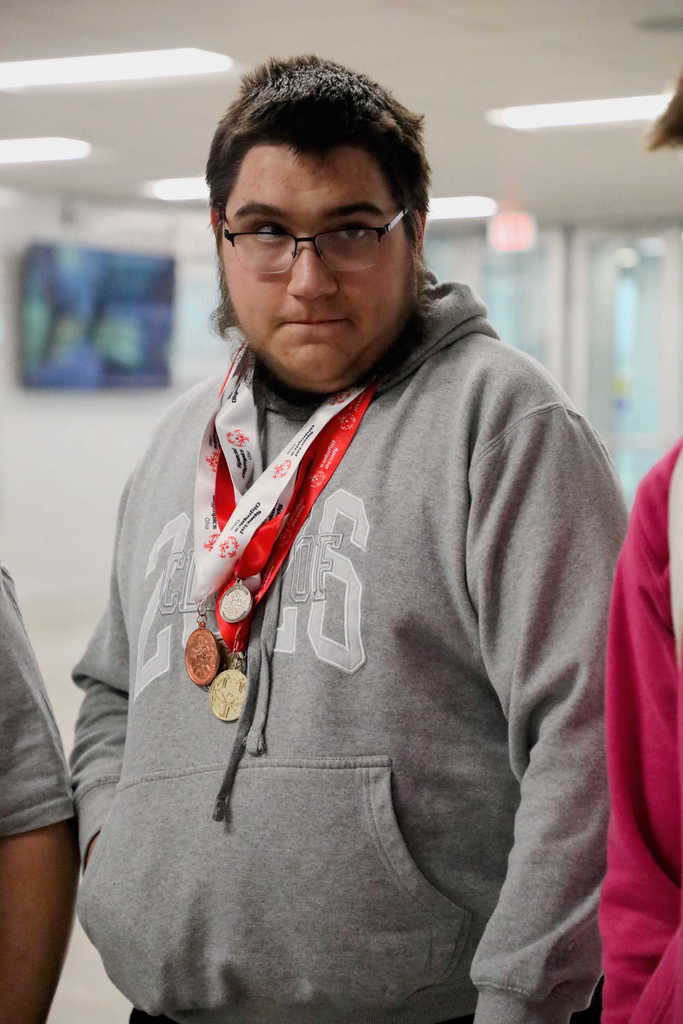 Ashton Carpenter closeup wearing Special Olympic medals