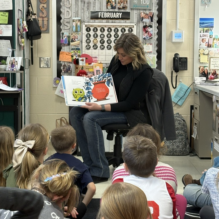 Emily Clark reading a story to students