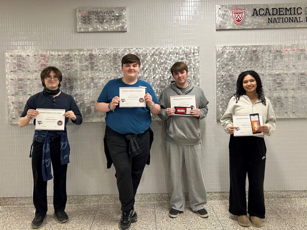 Students of the Month smiling with their certificates