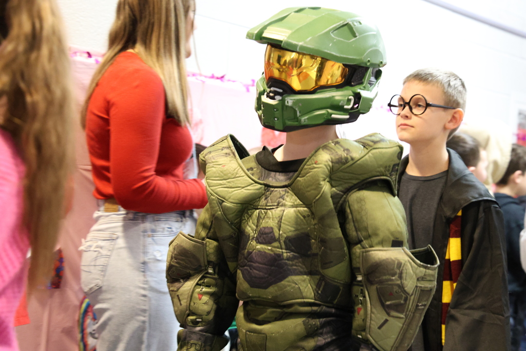 two male students dressed like a camouflaged robot and Harry Potter