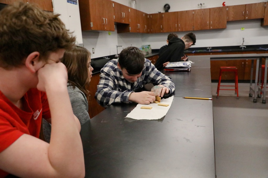 Students "welding" graham crackers held together with chocolate frosting
