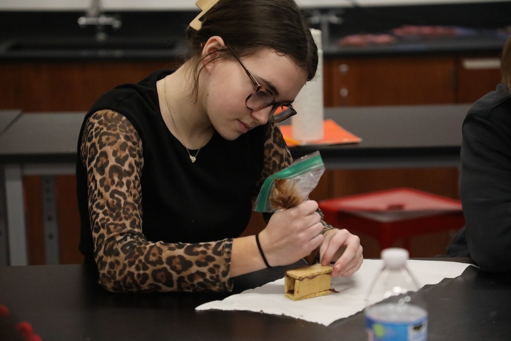Student "welding" graham crackers held together with chocolate frosting