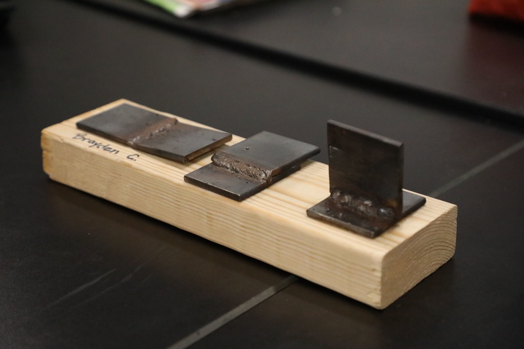 Board with welded pieces