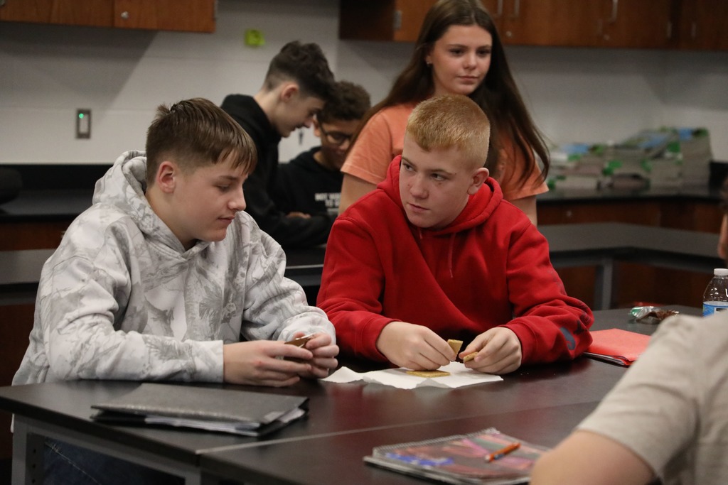 Students "welding" graham crackers held together with chocolate frosting