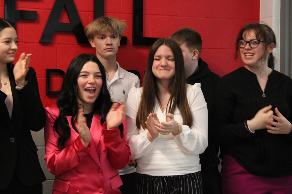 Students clapping and smiling