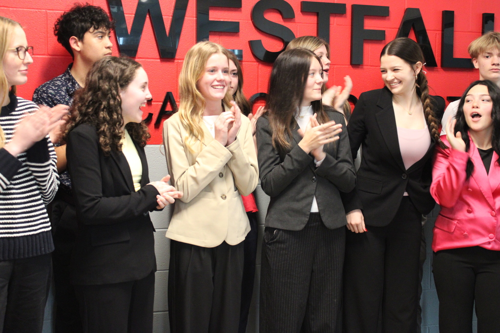 Students clapping and smiling