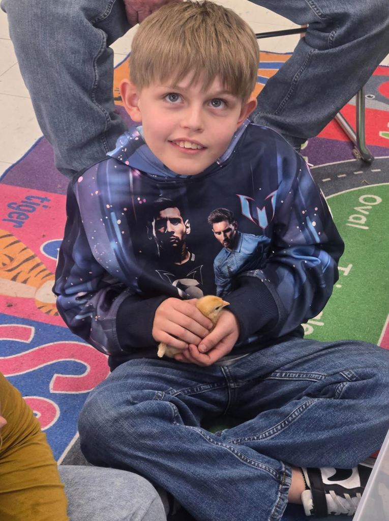 Student holding baby chick