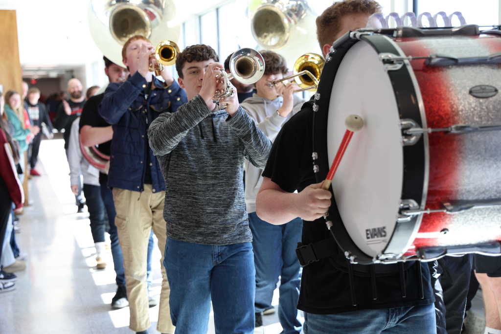 Students playing instruments in a hallway