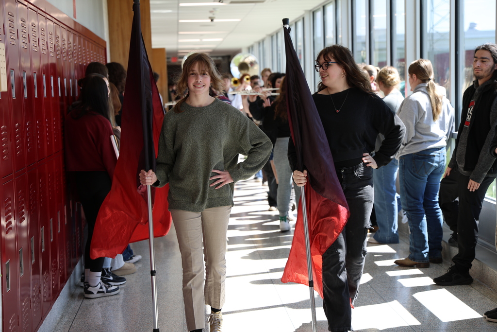 Students walking down the hallway with flags