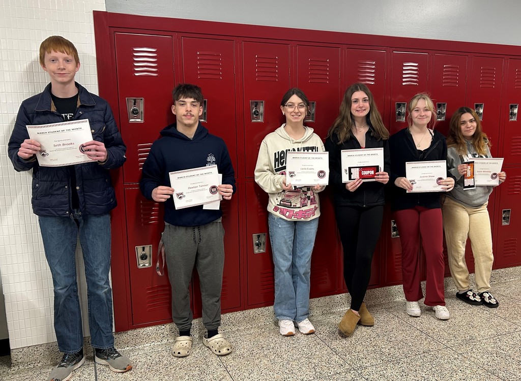 Students smiling and holding certificates